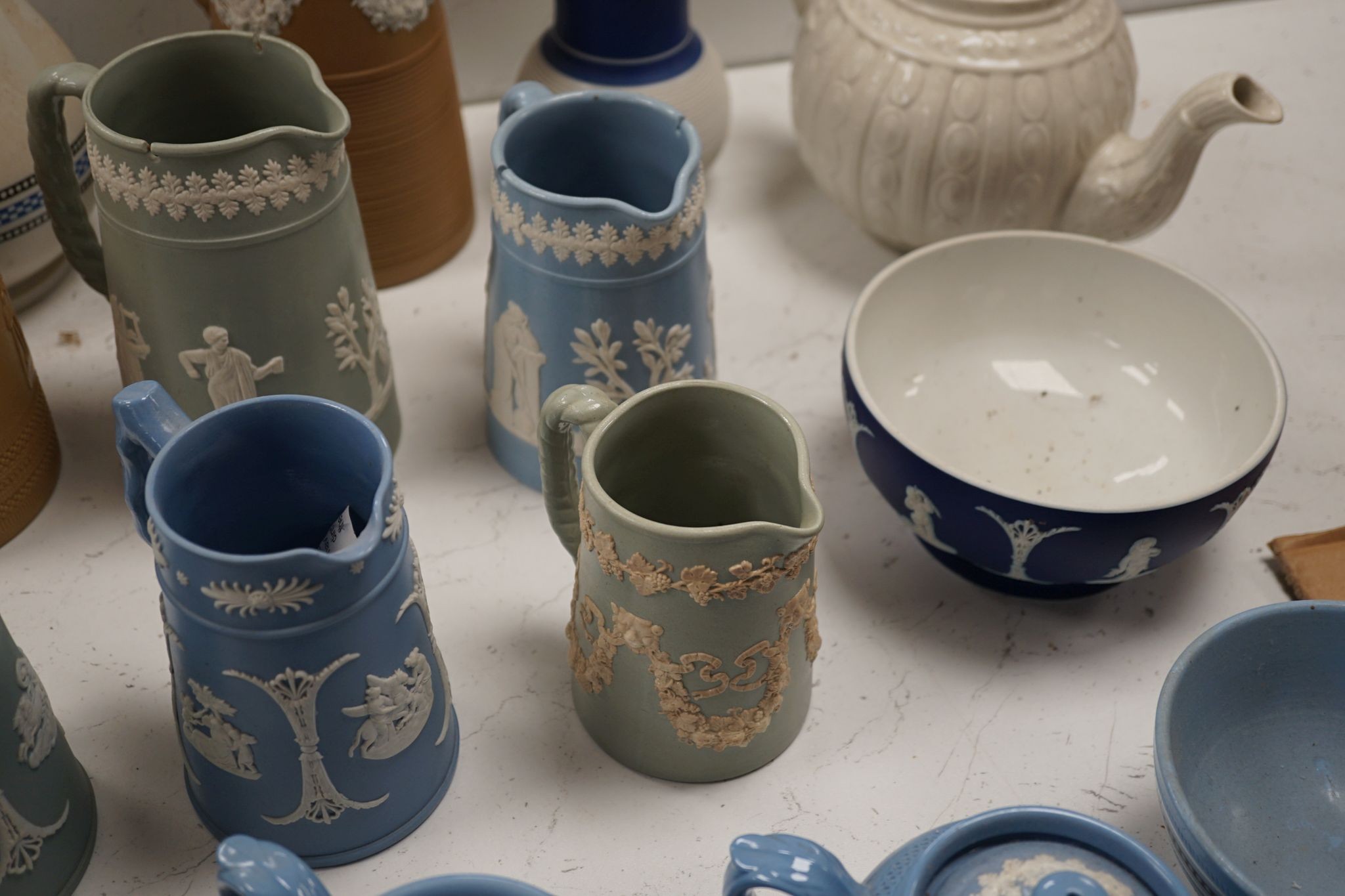 A collection of Dudson stoneware, including jugs, teapots, cream jugs etc, many decorated in low relief